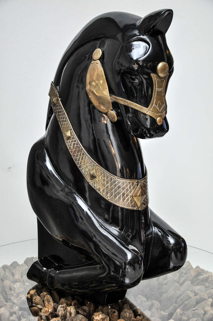 A unique black lacquered and brass horse sculpture