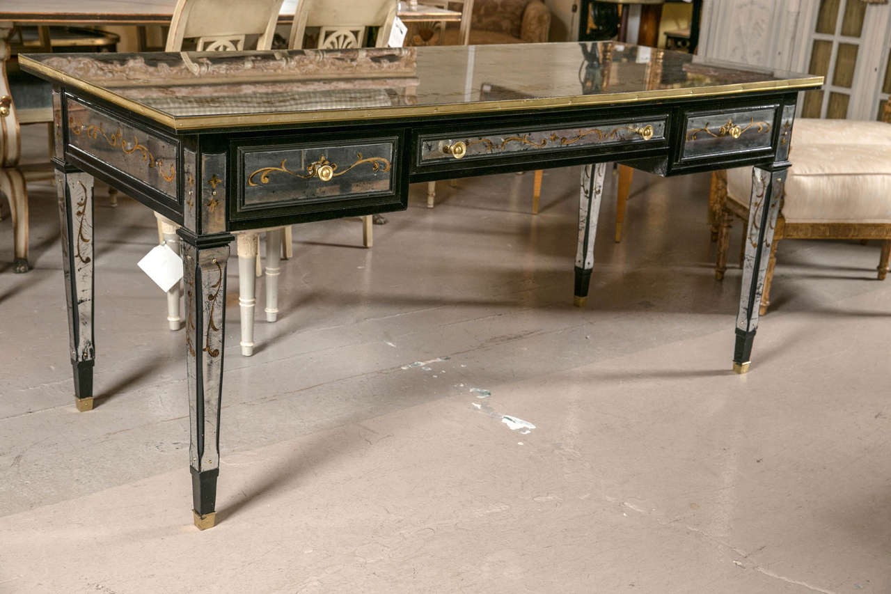 Maison Jansen Verne églomisé writing desk. This is simply one of the finest decorator desks on the market. The bronze sabots leading to a case of ebonized wood having legs, sides, back and top of fine églomisé decorated work. The top writing service