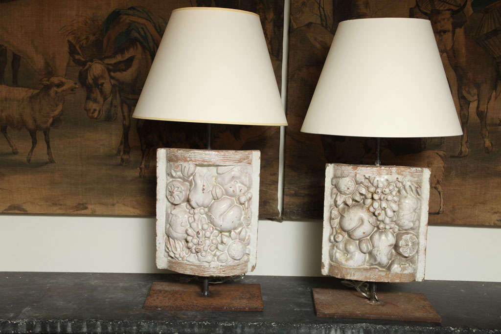 A pair of white faience table lamps with fruit decoration panel mounted on cast iron table base. Made of 19th century-early 20th century white faience fragment.