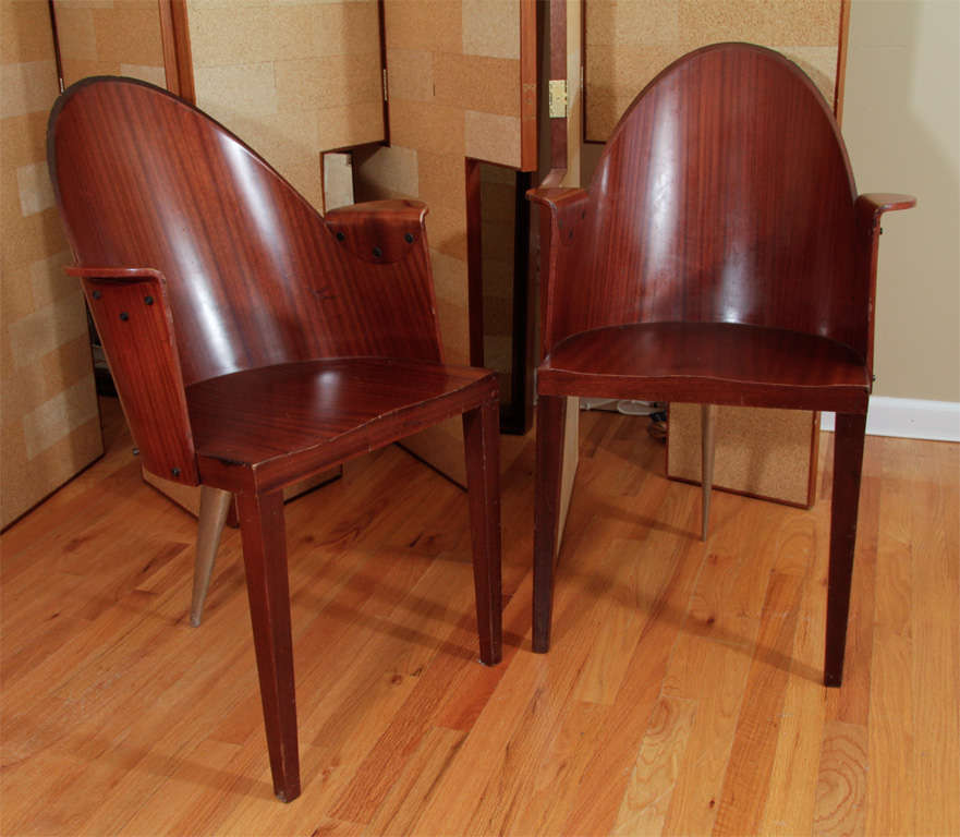 A pair of chairs in mahogany and stainless steel custom designed by Philippe Starck for the Royalton Hotel, one of his most iconic projects.

Seat Height: 17