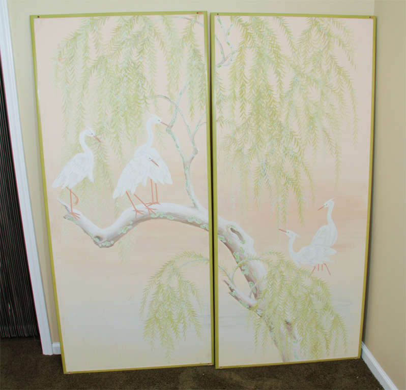 Hand-painted paper mounted to panels depicting five cranes, a Chinese symbol of longevity and auspiciousness, resting on a willow in shades of light pink and celadon green by California artist Robert Crowder.