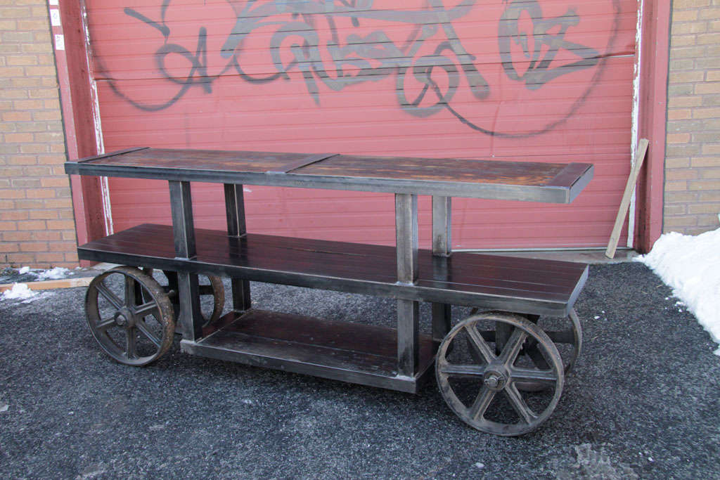 INDUSTRIAL CONSOLE DESIGNED WITH RECLAIMED OAK, ANTIQUE INDUSTRIAL WHEELS AND RECLAIMED STEEL