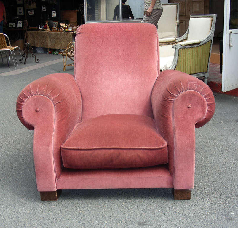 Two wide 1940s armchairs in their original pink velvet upholstery and wooden legs.