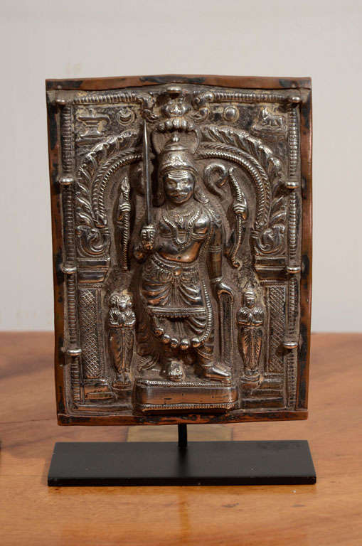 Sterling Silver Carved Shrine, Copper back and on custom iron base. Representing Vira Bhadra, fierce emanation of Shiva.
Vira Bhadra is enraged by the Vishnuite sacrifice made by Daksha
(with goat's head, left ). Vira Bhadra's consort Uma ( right