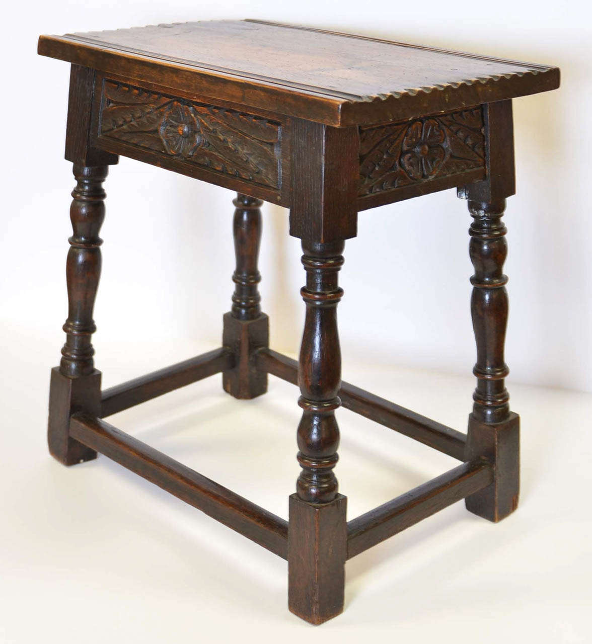 English Oak joint stool with beautiful carvings on all for sides.  From Enlgand circa 1890.

Item # JF103