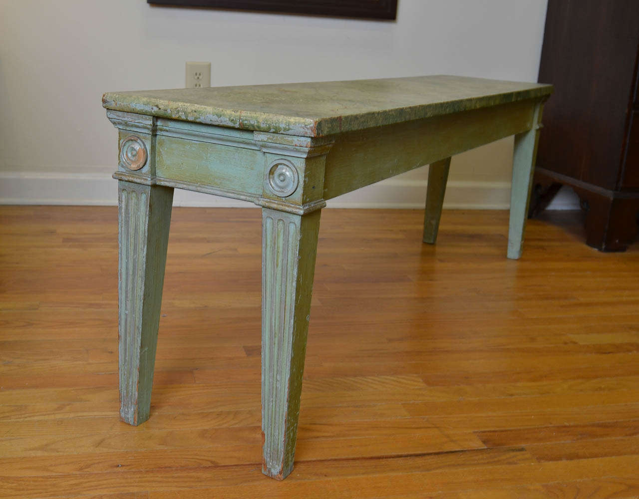This is an English bench from the 1920's.  It has been faux painted in a lovely two tonal green style