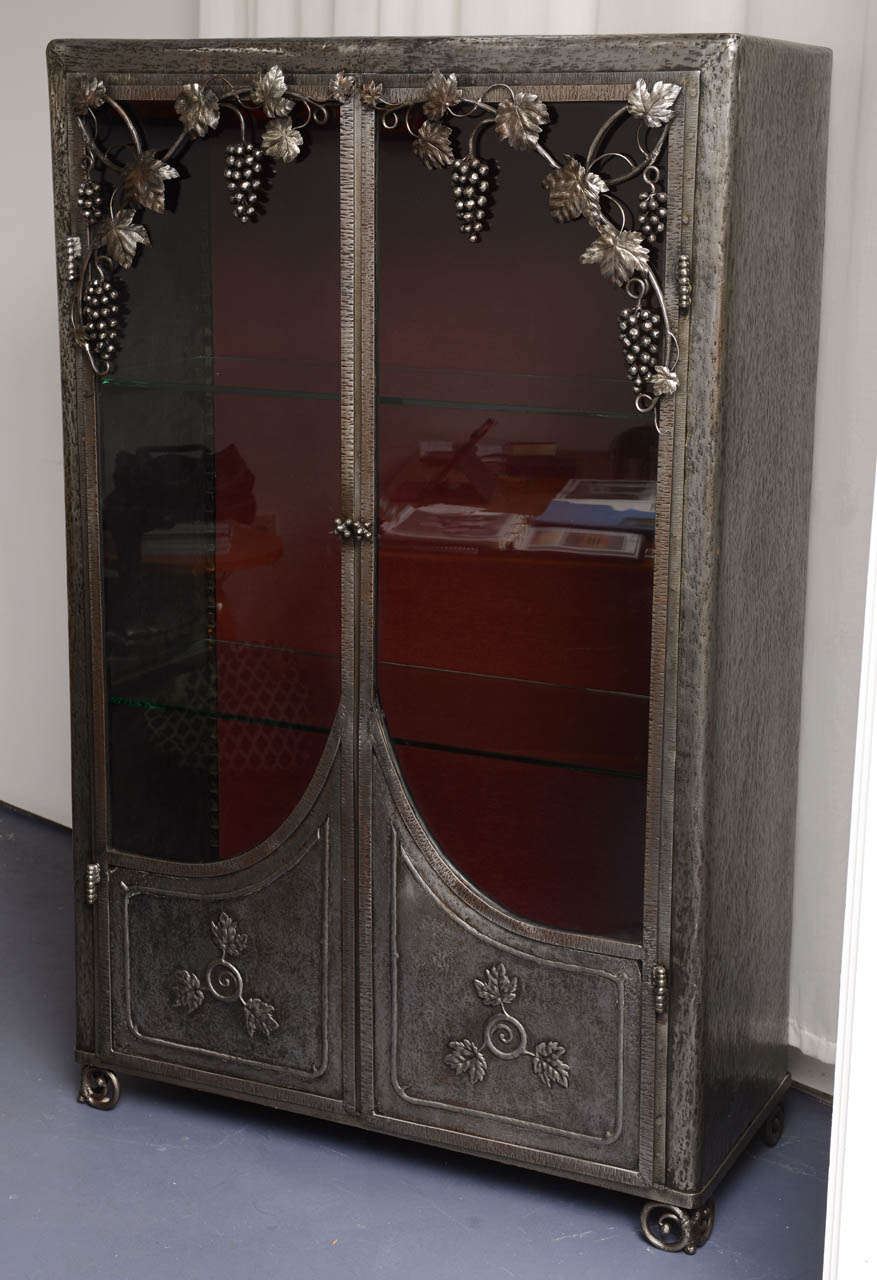 Very unusual and interesting craftsmanship for this iron French piece of furniture (circa 1925). This work is the exact tradition of the best French iron maker in this precise 1925 period of time.  The front part decorated on the theme of grapes. 