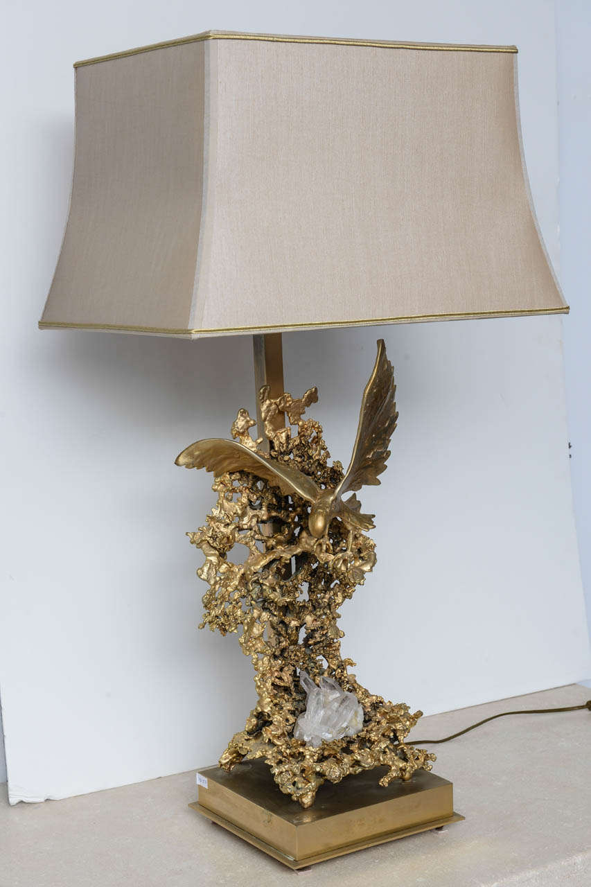 Sculptural lamp in golden bronze by Boeltz 
representing a Flying  eagle  ornamented by rock Crystal included in gilted metal structure
golden bronze and rock crystal makes the piece like a piece of jewelry.
The light of the lamp, gives to the