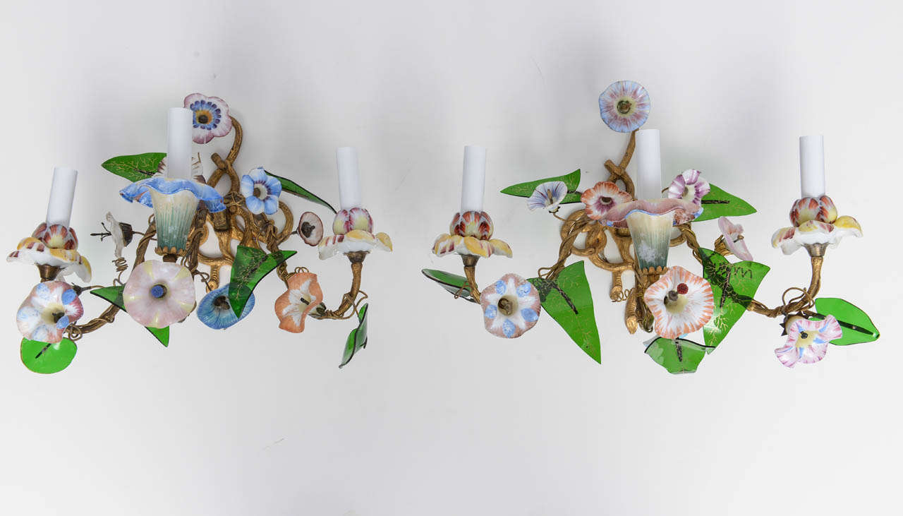 Fine and elegant pair of romantic sconces made of colored glass flowers, in the French Louis XV's style. 
Porcelain, colored glass flowers mounted on golden bronze branches and basket, 19th century, French Charles X period.
 