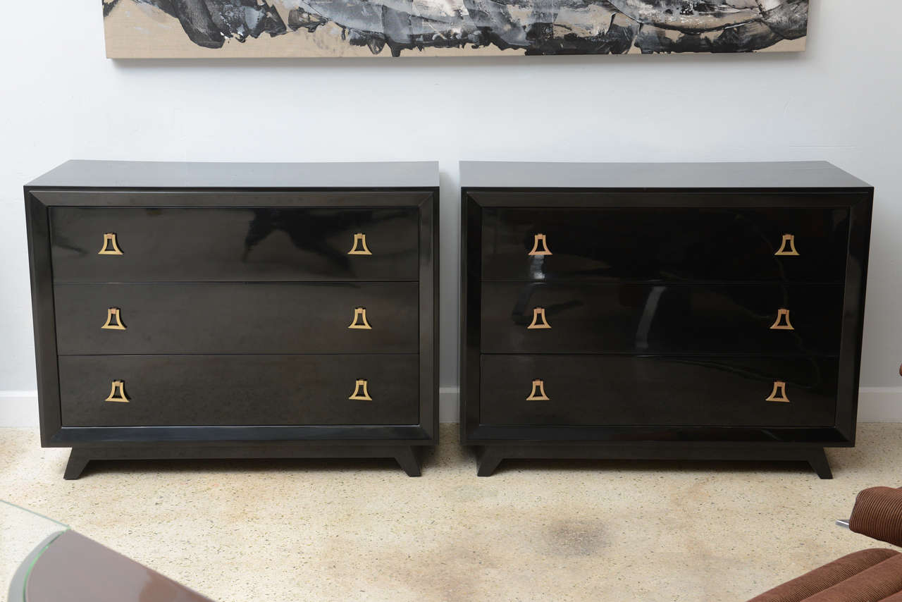 The rectangular top above a beveled frieze with three drawers with heavy brass ring hardware, on splayed legs.