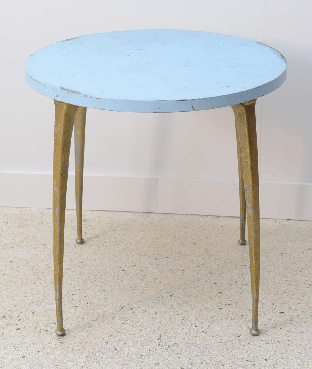 The blue enameled top above four splayed tapering brass legs.
Original condition.