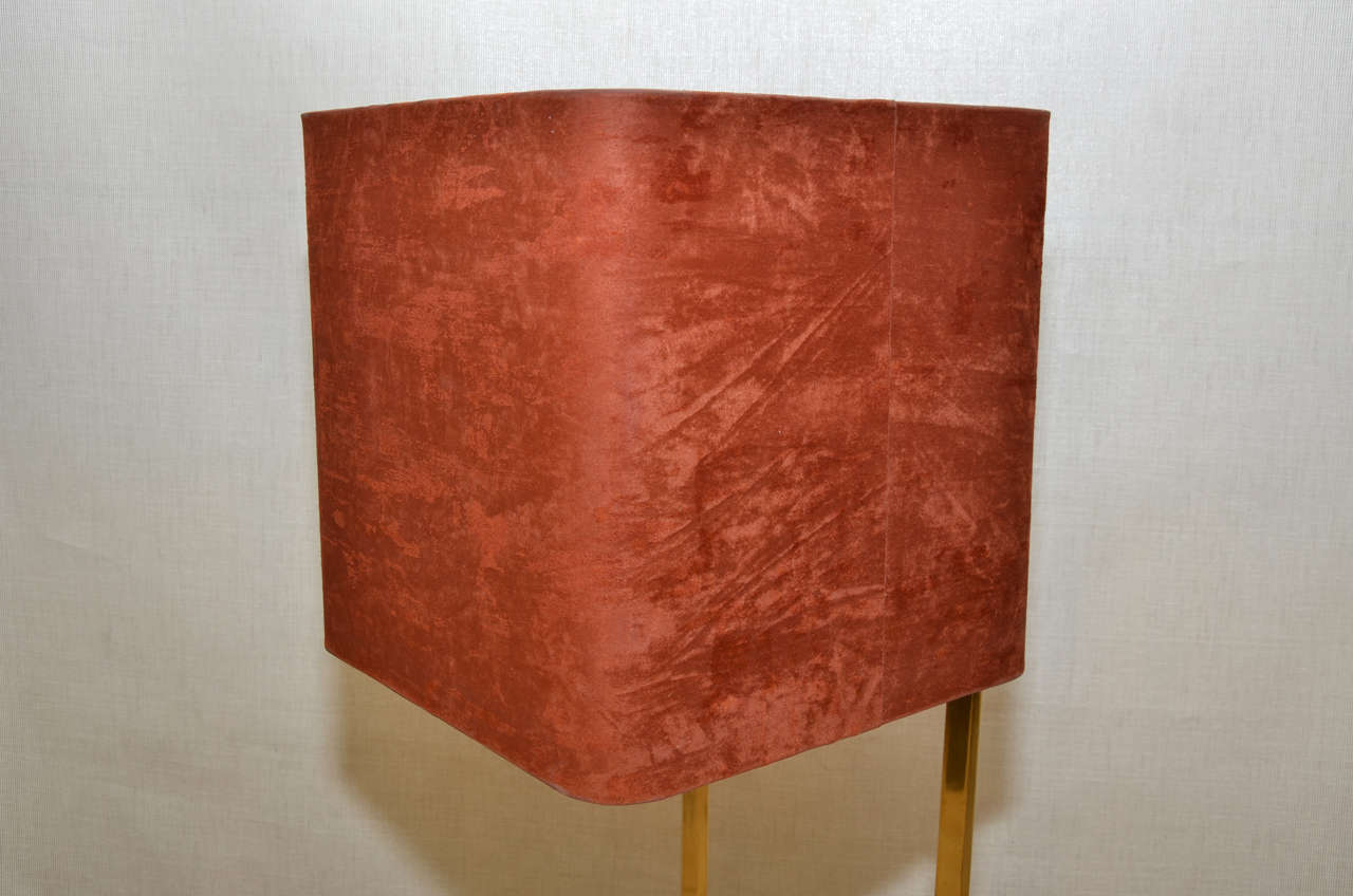 Large 1970s lamp with structure in gilded brass, base in black plexiglass; shade in Alcantara (imitation suede) with gilded interior; attributed to Maison Charles. Wired for European use.