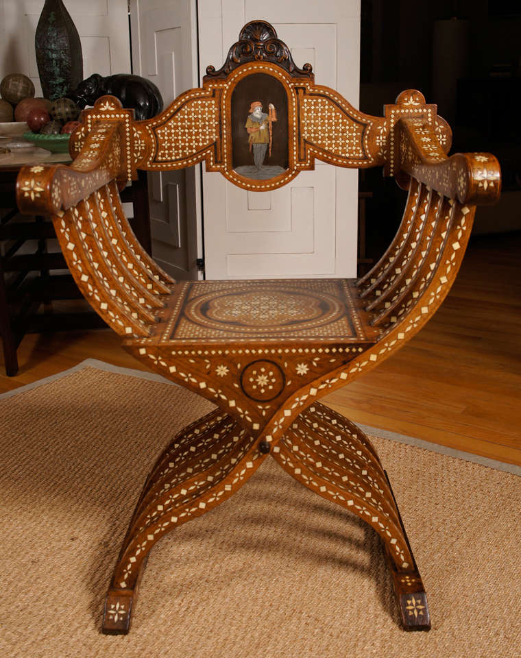 Hand carved Italian chair with decorative pattern inlaid in bone. Decorative back panel of a figure made of pewter, brass and bone.