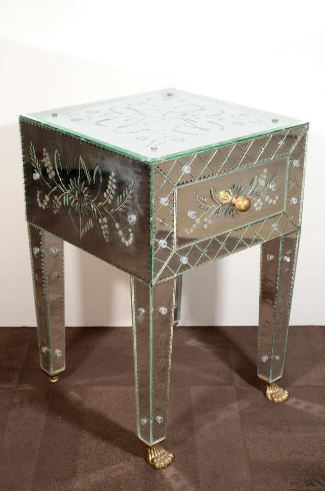 Pair of exquisite Venetian mirrored end tables or night stands with extensive reverse etched designs throughout. Hand beveled glass with chain beveled border details. The tables are fitted with single drawers with wood interiors. They have stylized