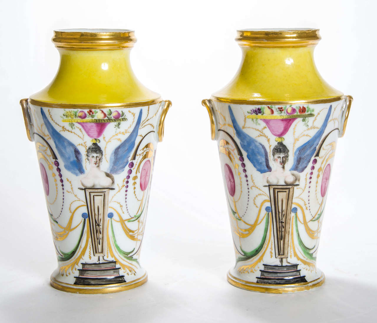 A pair of Coalport vases, decorated with winged caryatids and scrolling foliage.