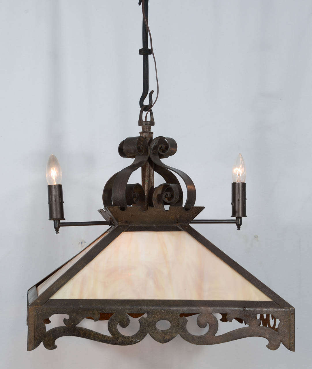 Early 1900s, combination of two-light gas and four-light electric, wrought iron with amber slag glass chandelier. This fixture originally hung from a gas pipe but in the conversion to all electric, has been adapted with a custom hand-wrought chain.