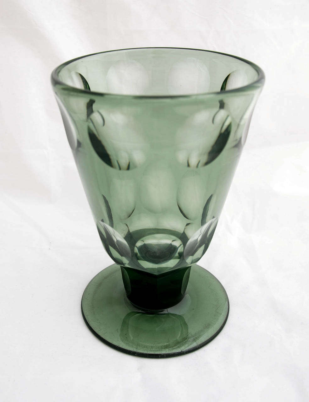 This is a striking and rare piece of 1930's design by the great Keith Murray. In green crystal, the chalice is 20cm tall and 13.5cm in diameter. Made by Stevens & Williams in Stourbridge, UK (pattern number 695a), the broad stem is slice cut with 6