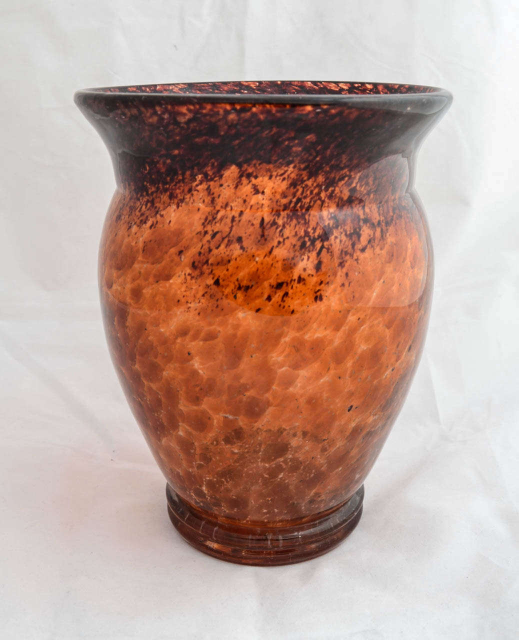 This beautiful quality hand blown vase could be confused with Monart from Scotland, with it's mottled, almost tortoiseshell-like finish with white inclusions and black streaks towards the flared rim. But the shape, with a double foot and rim flared