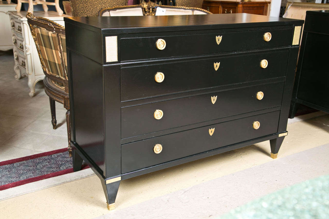A fine custom quality Baker Furniture Company Bachelor Chest.  Fine oak interior piece has bronze cookie corner decorations as well as bronze capped sabots and uppers.  Originally ebonized at Baker workshop and details appear to be later added. The