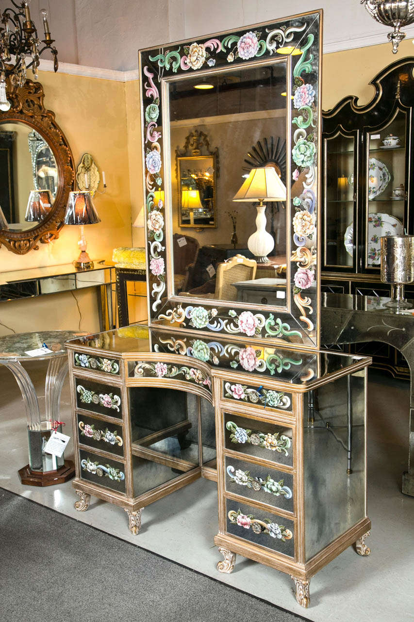 Venetian style vanity or dressing table, limed oak veneered with reverse-painted mirror panels, depicting beautiful floral and foliate motifs, the pedestal style table having an curved frieze flanked by a set of drawers on each side, raised on