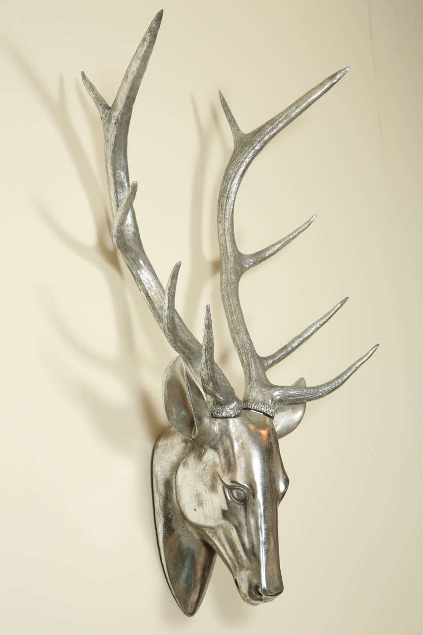 Metal deer head sculpture with a silver finish.    The sculpted head is beautifully realistic.
