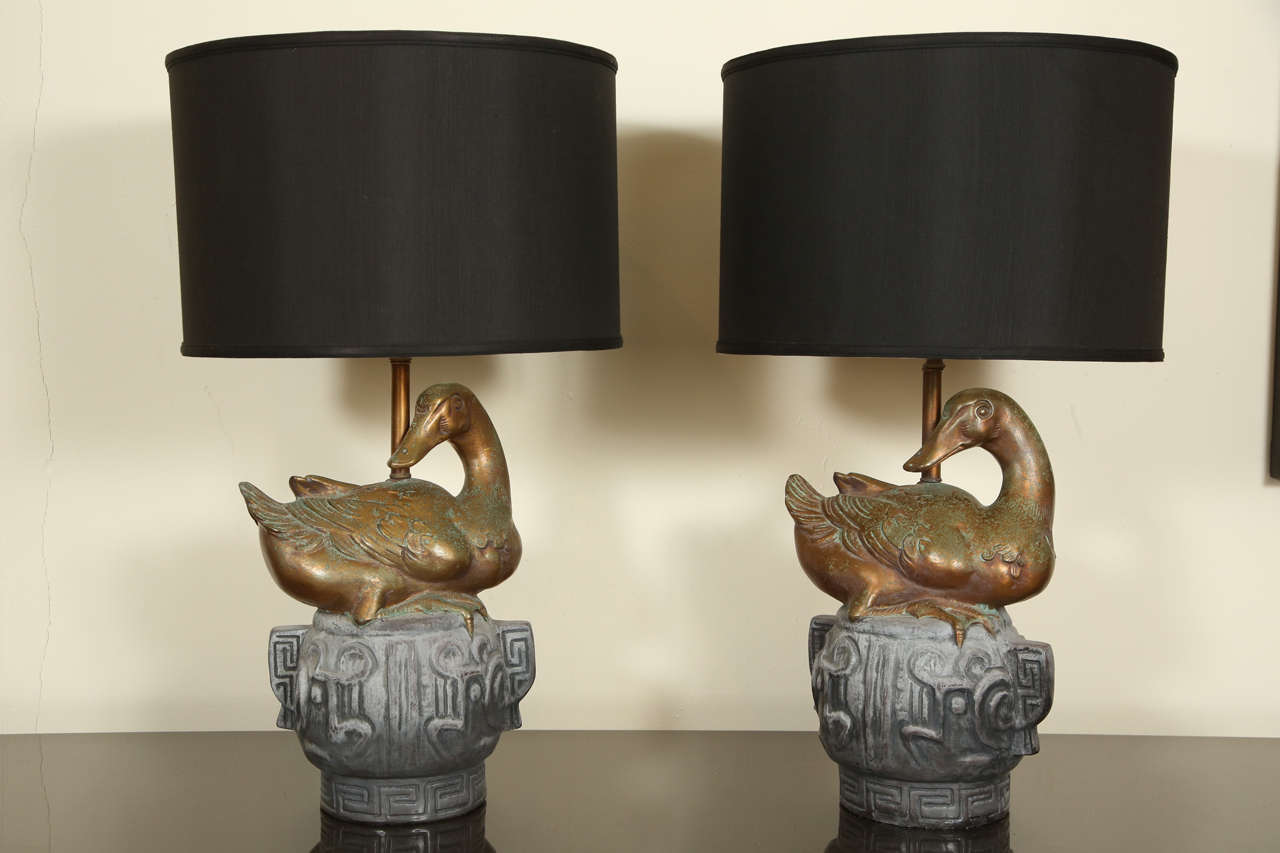 Pair of large ceramic table lamps.  The bases are in the form of Chinese bronzes with a very naturalistic gilded duck sitting on top.