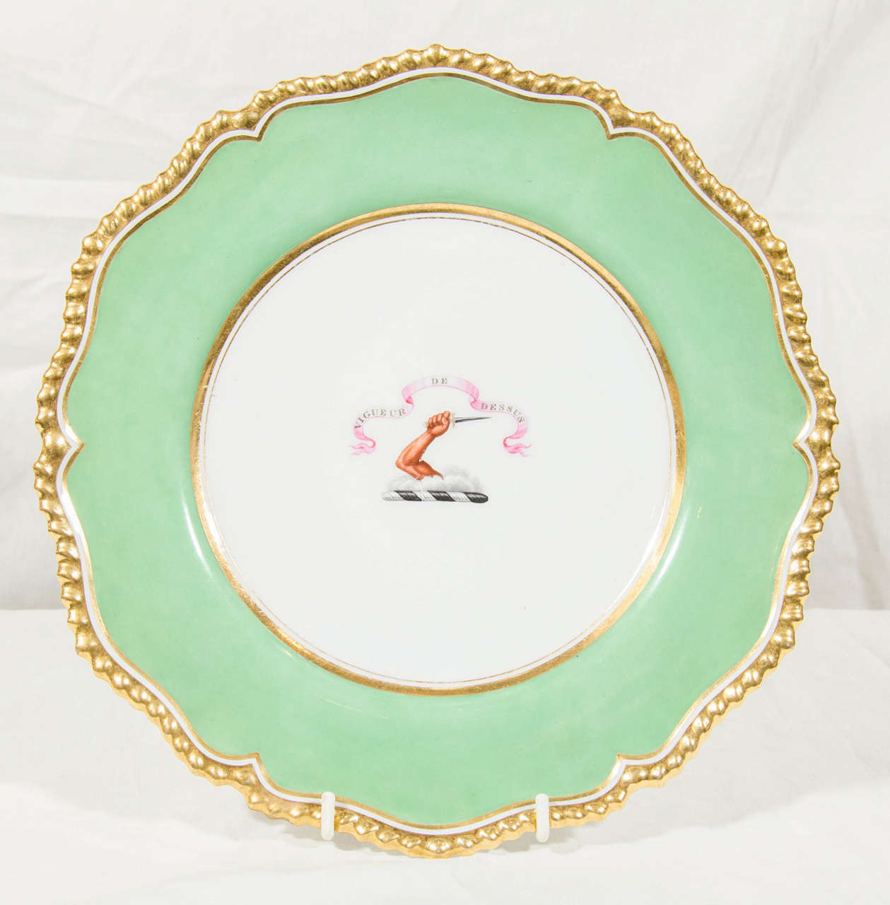 The Crest of O'Brien is at the center of this pair of Flight, Barr & Barr Worcester, George IV, porcelain dishes with apple green borders, and gilded edges. The crest with the motto: Vigueur de Dessus [Strength is from Above]  along with its