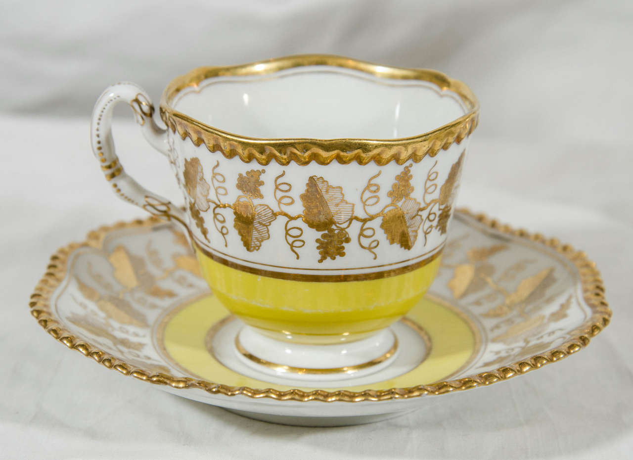 A set of four Chamberlain's Worcester yellow tea cups and saucers each with a broad border of gilded grape leaves and a gadrooned and gilded edge.
In this pattern we also have a matching pair of dishes 10