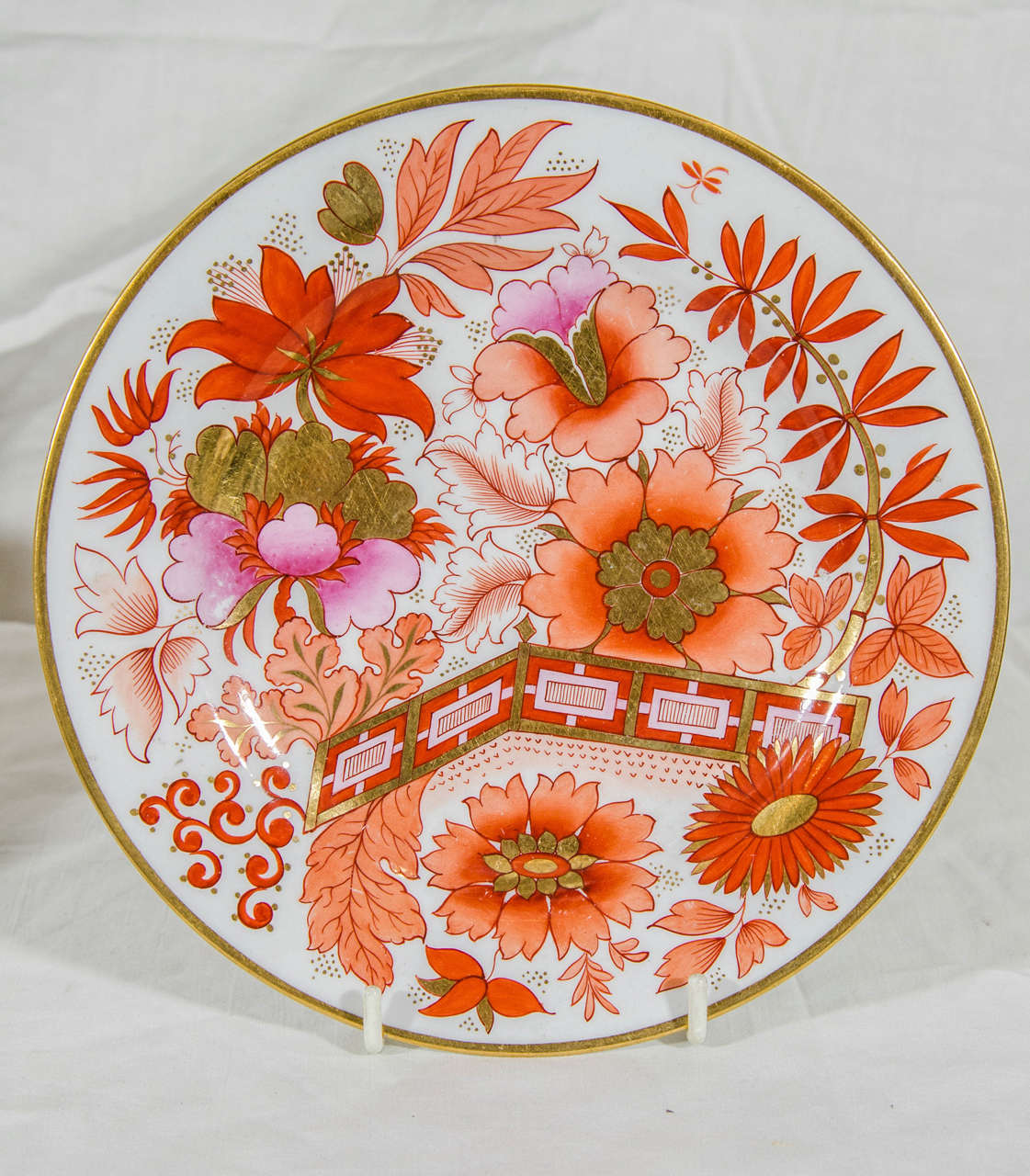A beautiful pair of Barr Flight Barr Worcester dishes decorated in Famille Rose style with a variety of flowers in a fenced garden painted in pinks and oranges highlighted with the highest quality gilt.