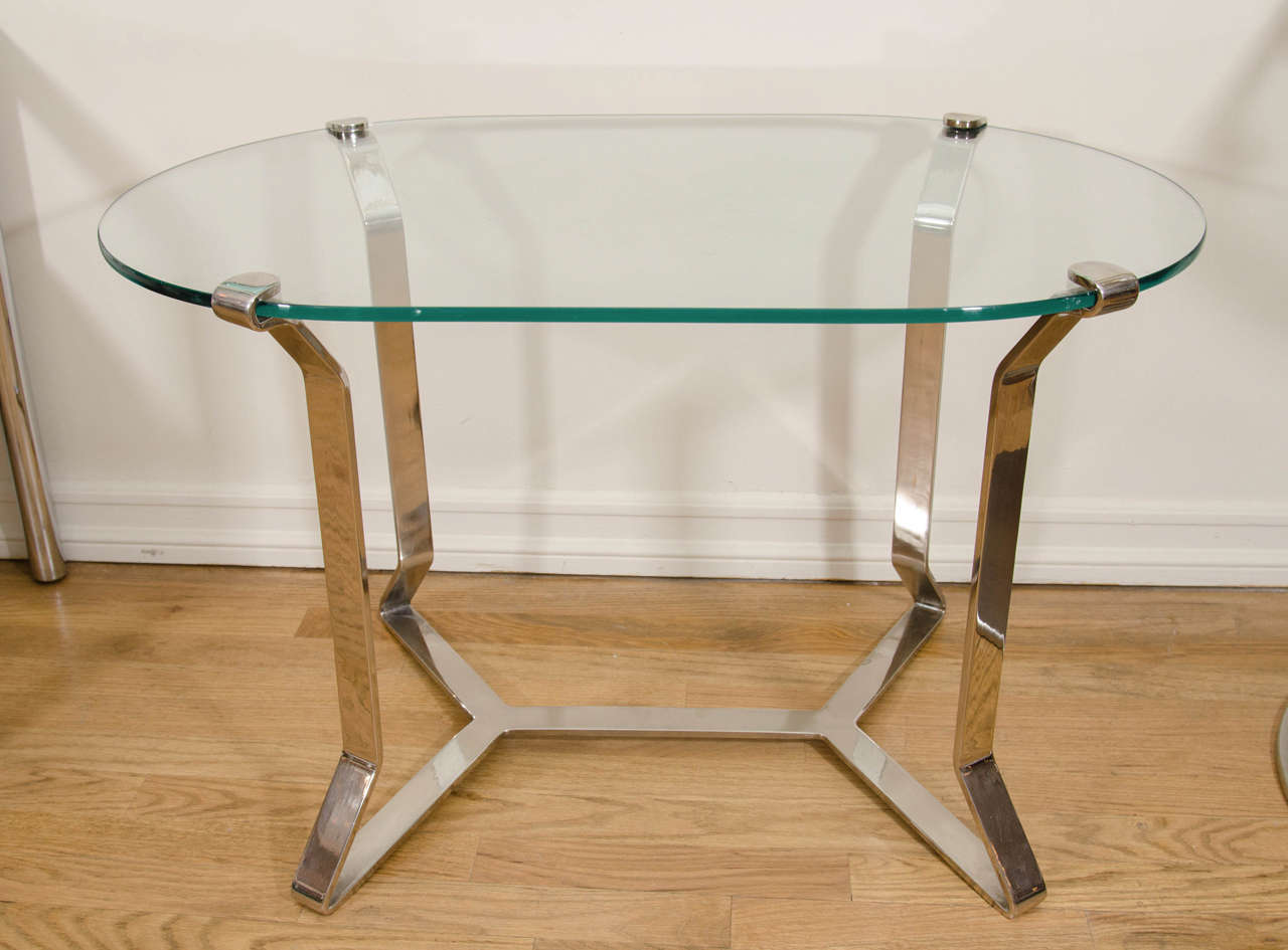 Single ovoid glass top nickel clip side table. Also available in brass.