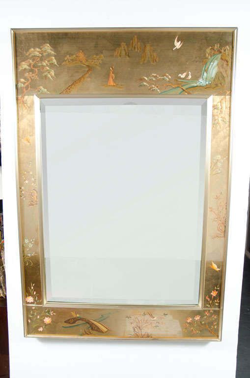 A reverse painted glass frame mirror with a bucolic scene of birds, waterfalls and foot bridges surrounded by a beveled edge and fluted anodized brass banded frame. Signed 