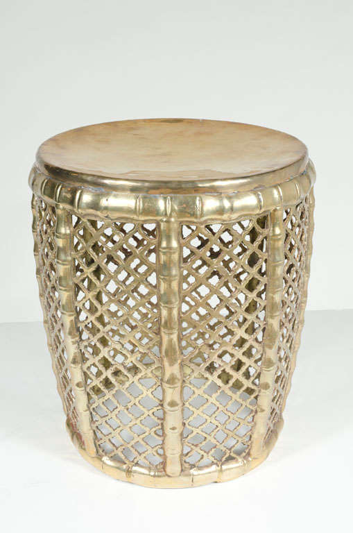 A polished brass tabouret table in a tapered drum form with a faux woven wicker and bamboo design. Indian, circa 1960.
