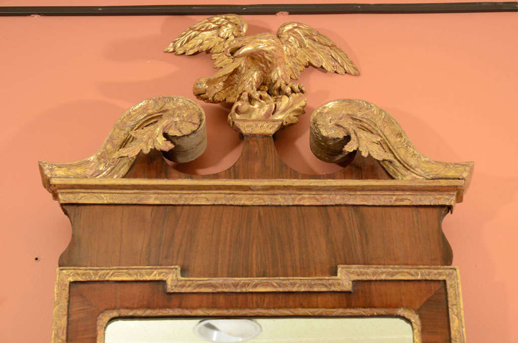 A fine and rare pair (left or right) of George II scroll top walnut and gilt mirrors with carved eagles, carved and molded giltwood scroll tops with acanthus and molded giltwood edges.