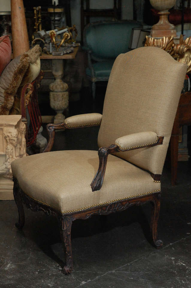 French open arm chair. Reupholstered in Rose Tarlow linen. Carved walnut with spaced nail heads.