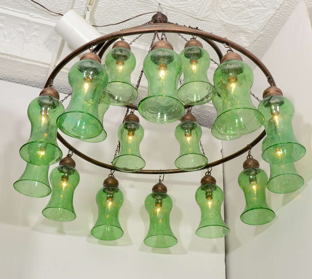 Two-tiered Egyptian chandelier with light green bell-shaped glass and bronze rings. Available in custom sizes and with silver finished rings.