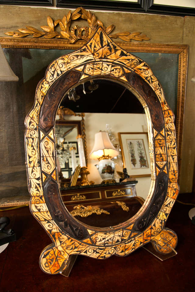 FRAME OF CARVED AND INKED BONE, CARVED WOOD, TO EITHER HANG OR STAND ON TABLE TOP.
FOLK ART TRADITION OF ALASKAN NATIVES.
PLEASE FEEL FREE TO CONTACT US DIRECTLY USING THE CONTACT DEALER LINK HERE OR  CALLING 203-263-1913