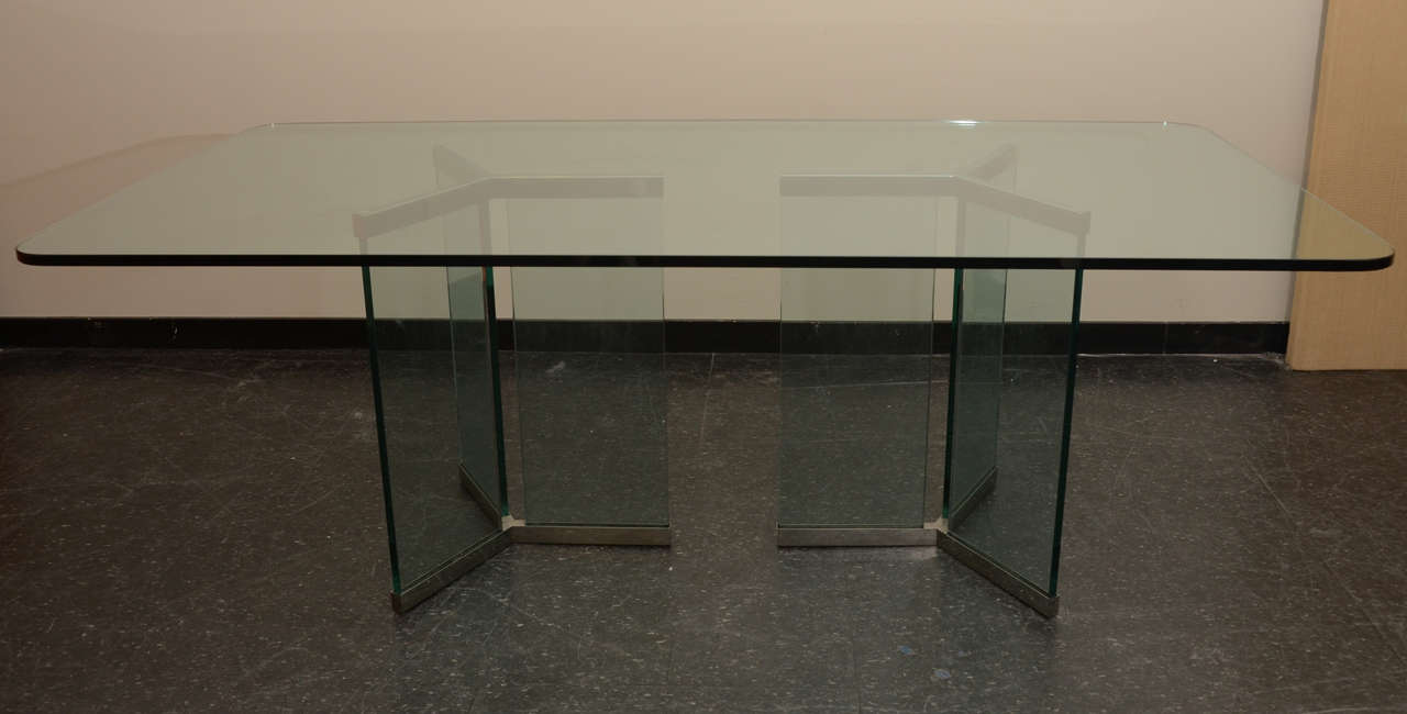  Glass and chrome pedestal bases support the 3/4