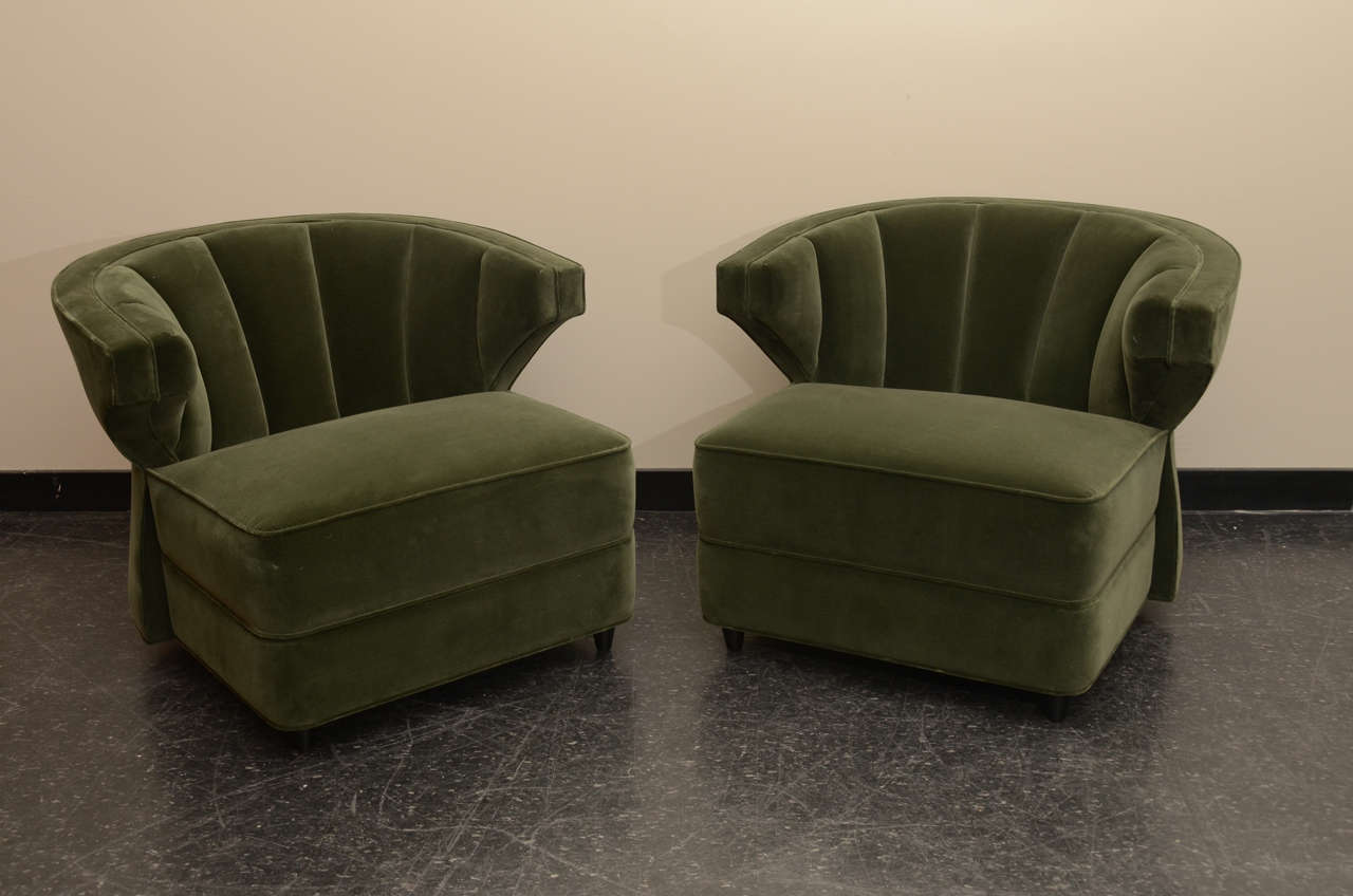 Wonderful pair of club chairs by James Mont. The chairs haver been beautifully reupholstered in a green velvet fabric.