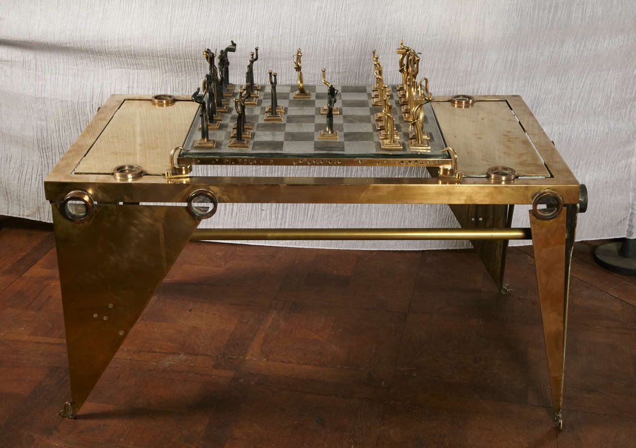 Brass chess table. 
Black and white sanded glass chessboard.
All pieces stamped.