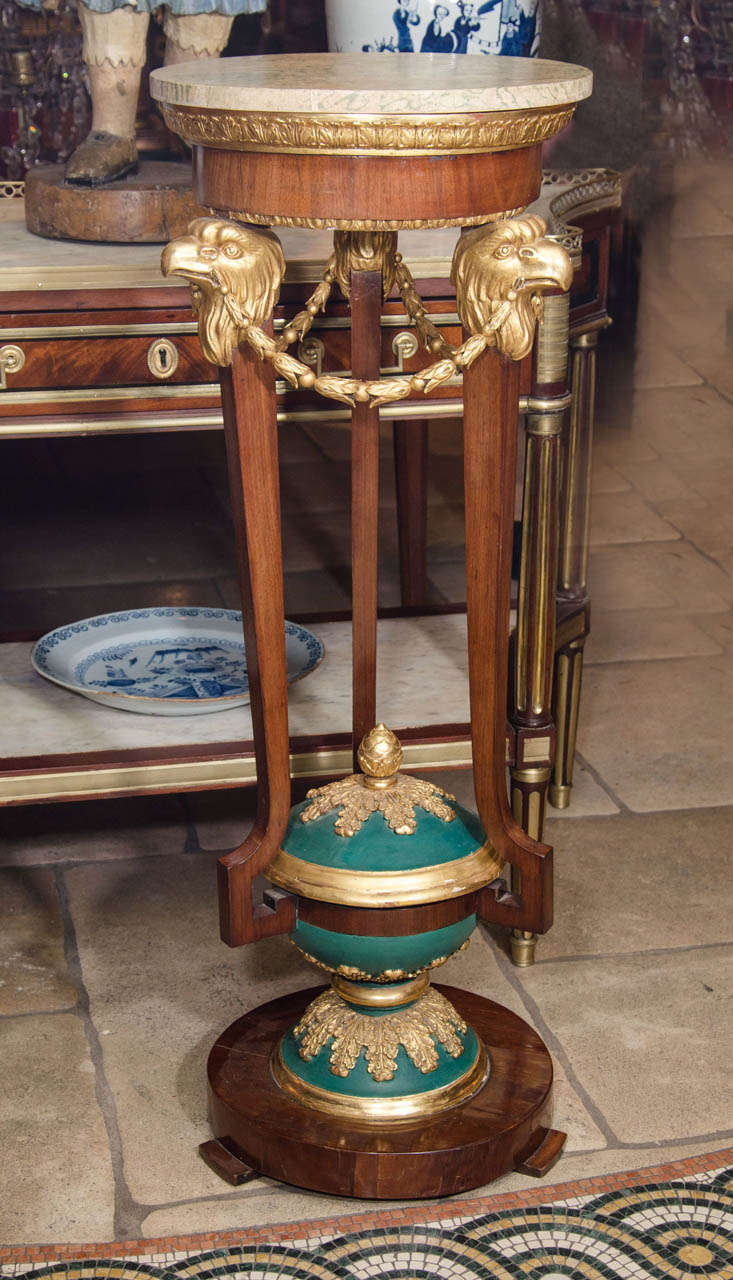 An unusual pair of Baltic walnut, gilt and painted pedestals with carved eagle heads, bell flowers, acanthus leaves and acorn with a removal lid and jardiniere on base.
