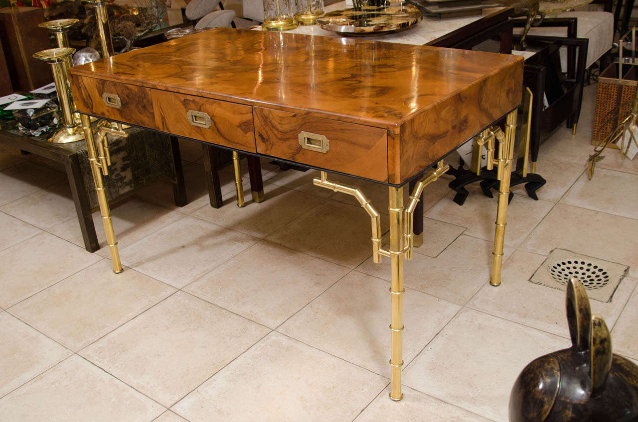 Rectangular burl wood three drawer desk with brass faux bamboo details.