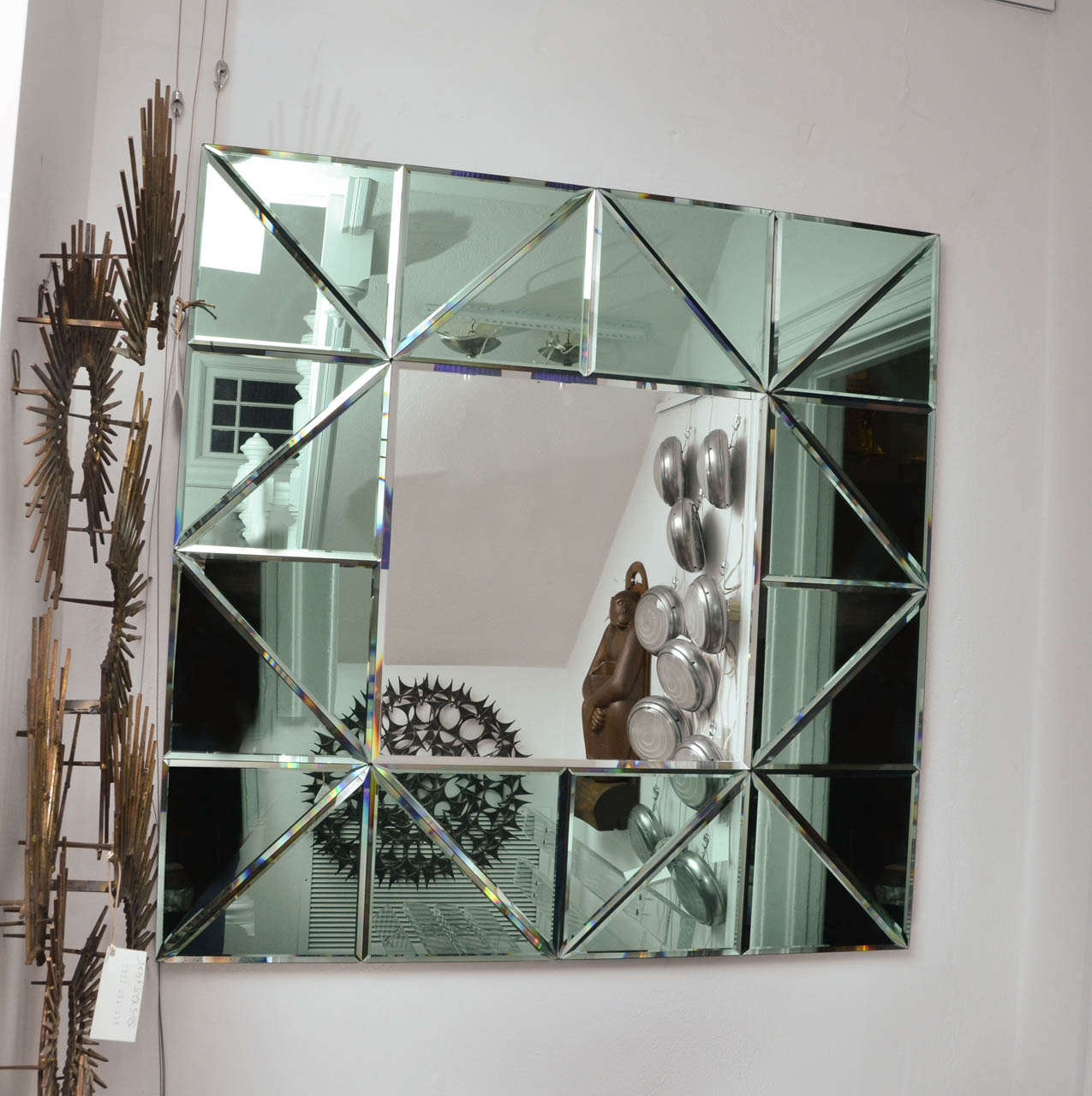 Triangles of green glass mirrors form a beautiful framed mirror with a hint of Deco.