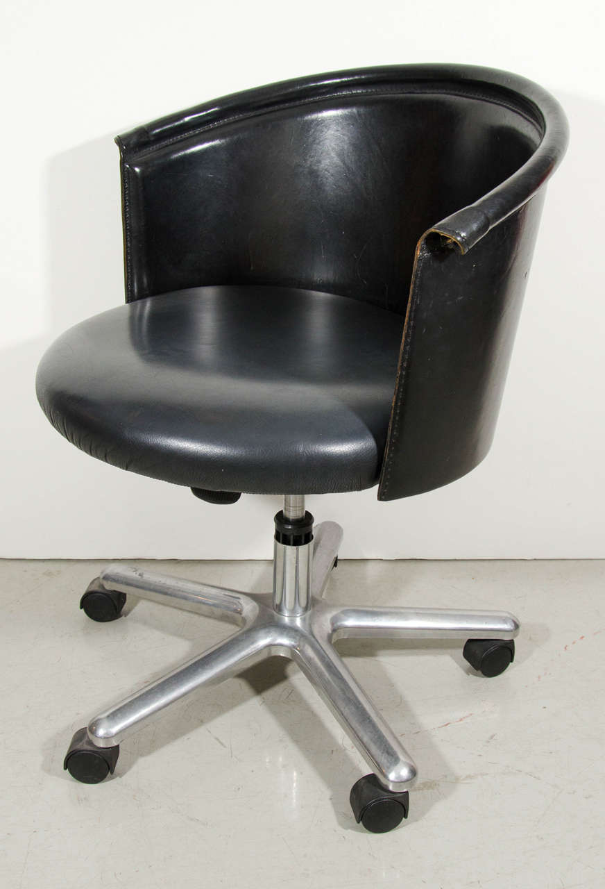 Classic black leather Italian bucket chair with wheels. Sits comfortably behind any desk with this stylish and functional chair.