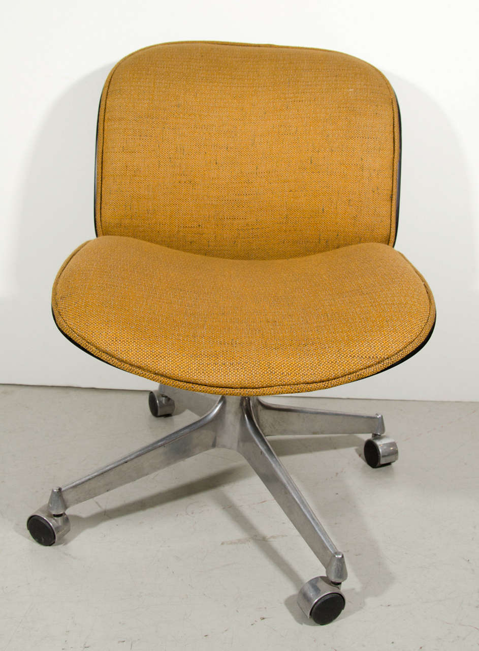 Classic Ico Parisi armless desk chair on wheels with wheat colored fabric seat.