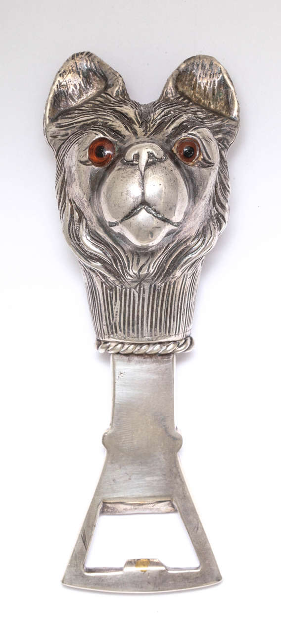 A charming silver plated bottle opener with the head of a French bulldog with glass eyes.