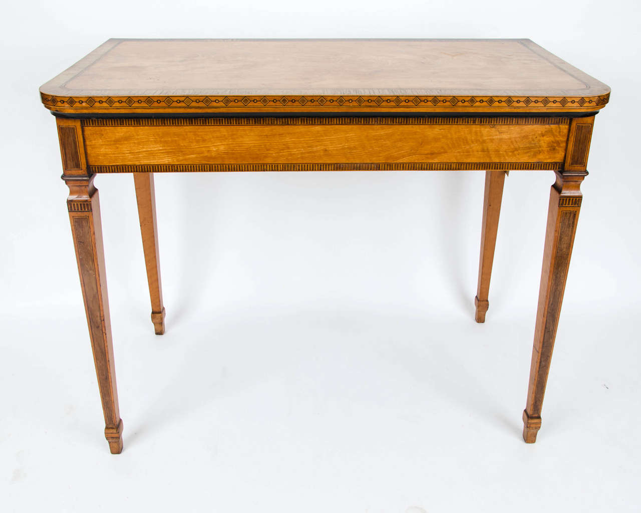 A George III Satinwood, Indian Rosewood-crossbanded  and amaranth inlaid card table with gate leg action and green baized interior.