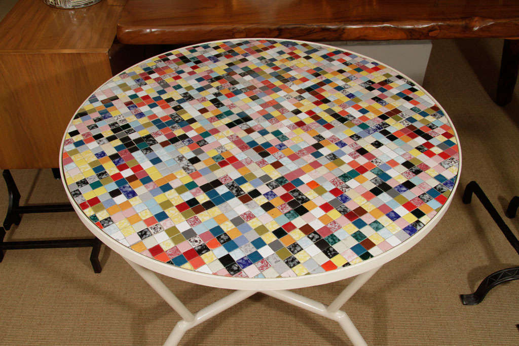 Top made of dozens of different colored tiles.