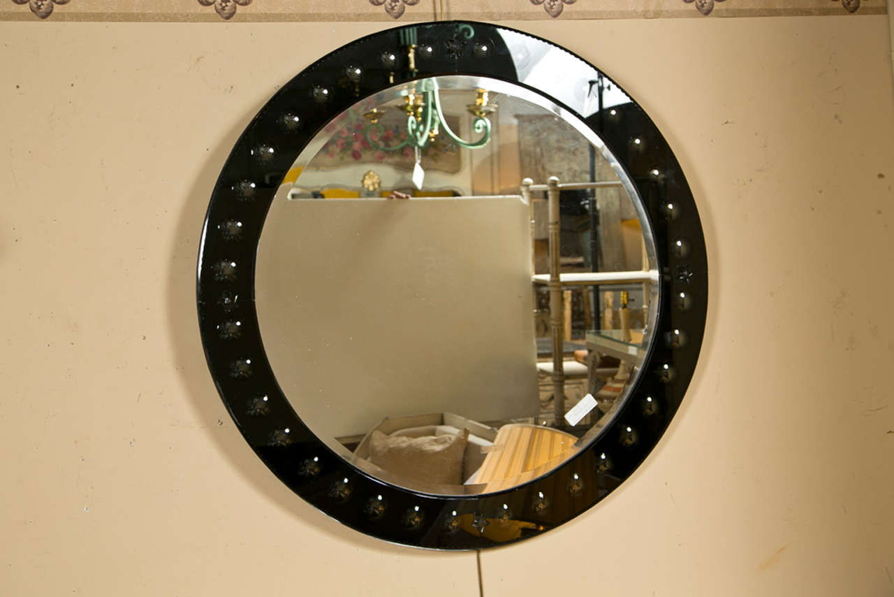 A Mid-Century Modern style single round mirror, 20th century, the border with glass panels decorated with bubbles and star ornaments.