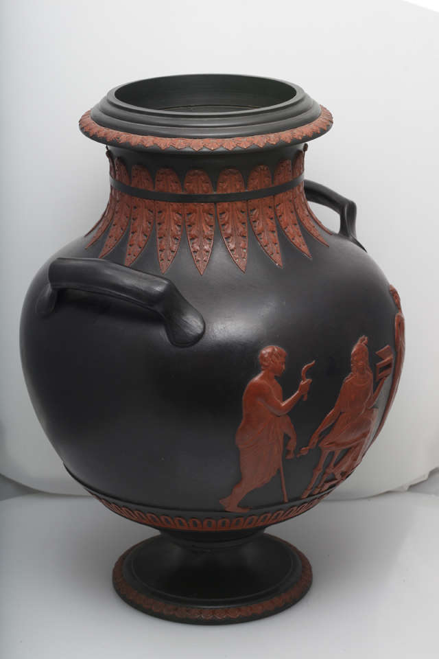 A rare and fine signed Turner basalt two handled vase with classical figures and leaves in brown relief