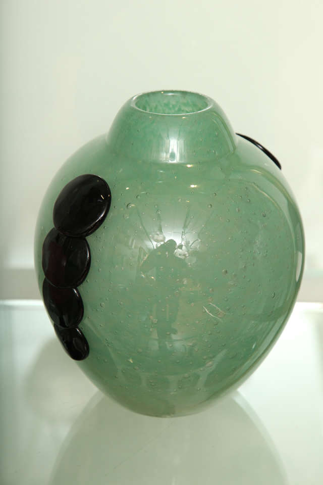 Charles Schneider.
Green glass vase with applied black glass decoration in the Emeraude pattern, from circa 1925, engraved: Schneider.
9-3/4 inches high (24.8 cm).
Reference: C. Schneider glassworks, p. 319, Joulin and Maier.
 